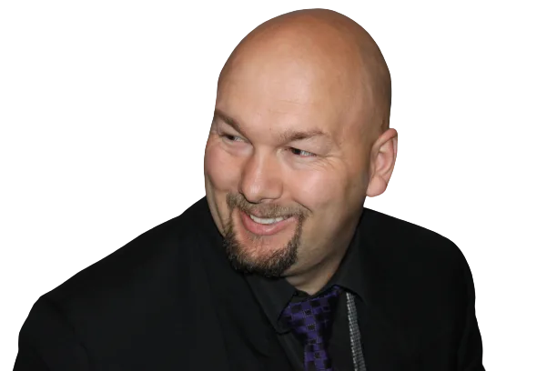 Jesse Lewis smiling in formal attire – comedy hypnotist promotional headshot