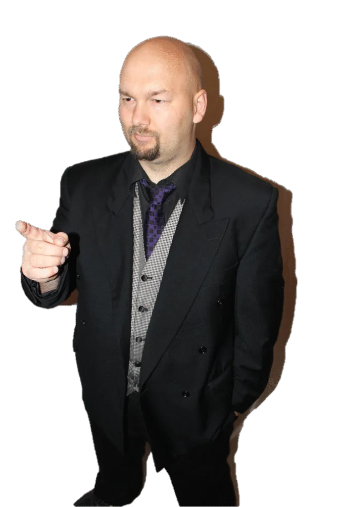 Jesse Lewis in black suit pointing confidently – stage hypnotist headshot