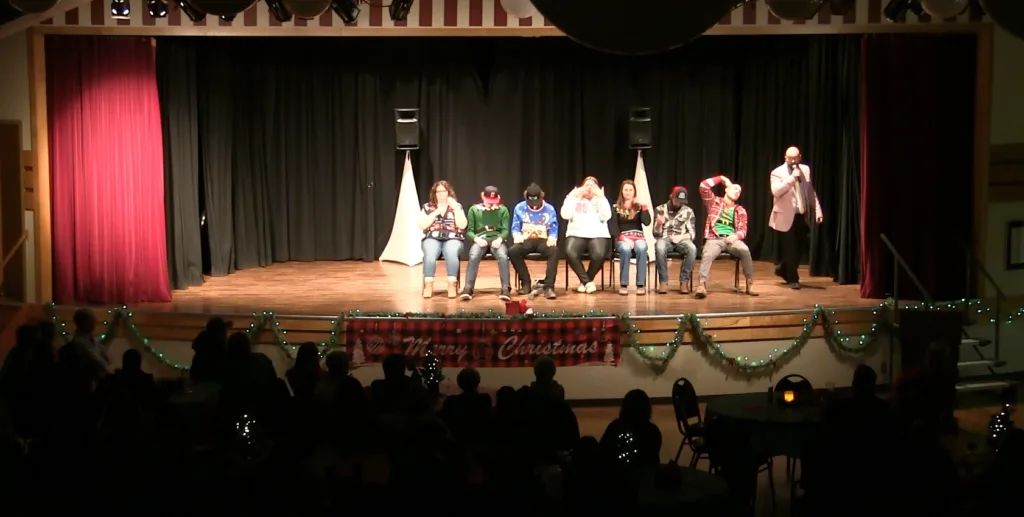 Interactive party entertainment with volunteers participating in a live hypnosis show
