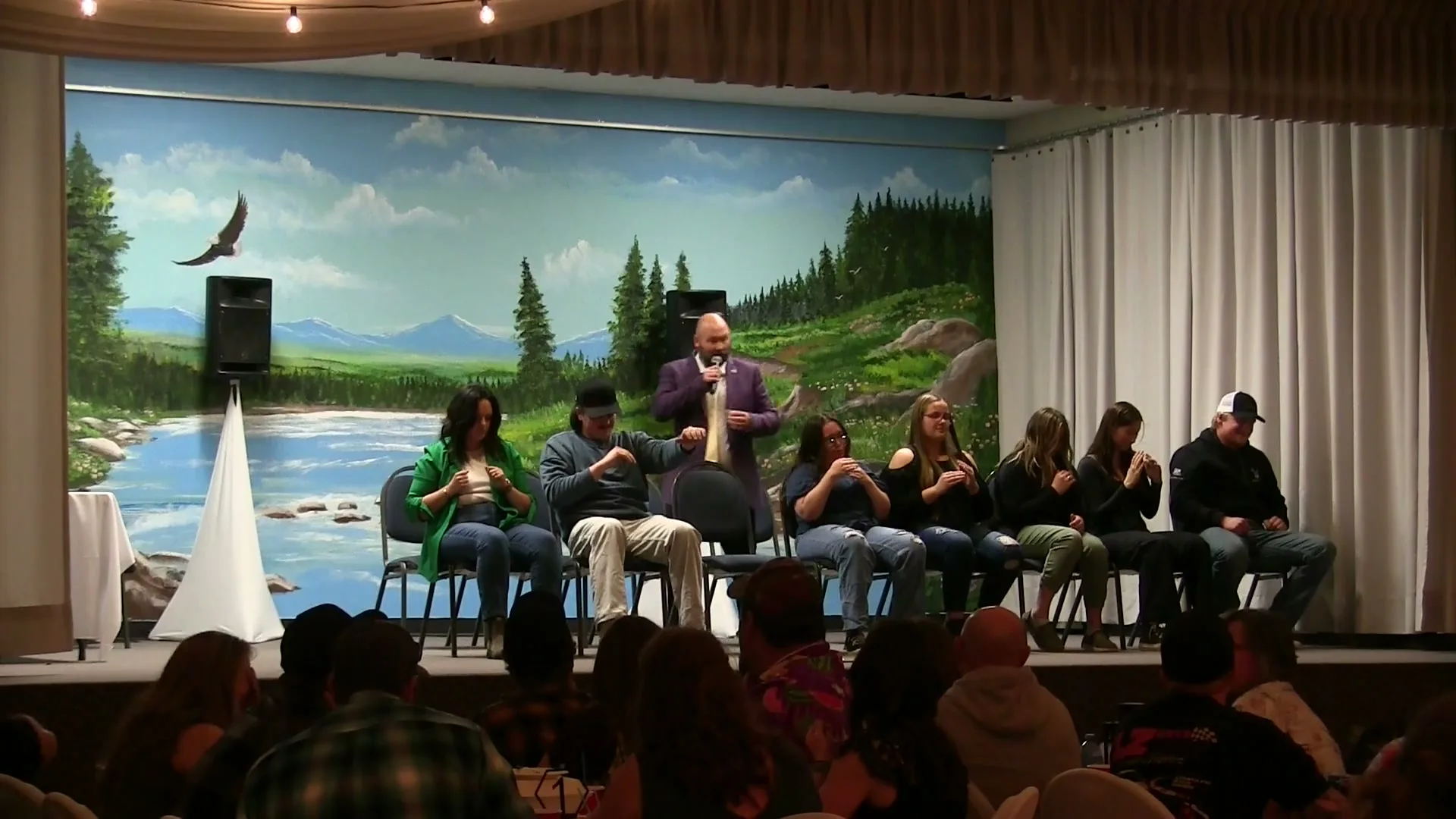 Jesse Lewis directing volunteers during an interactive comedy hypnosis show