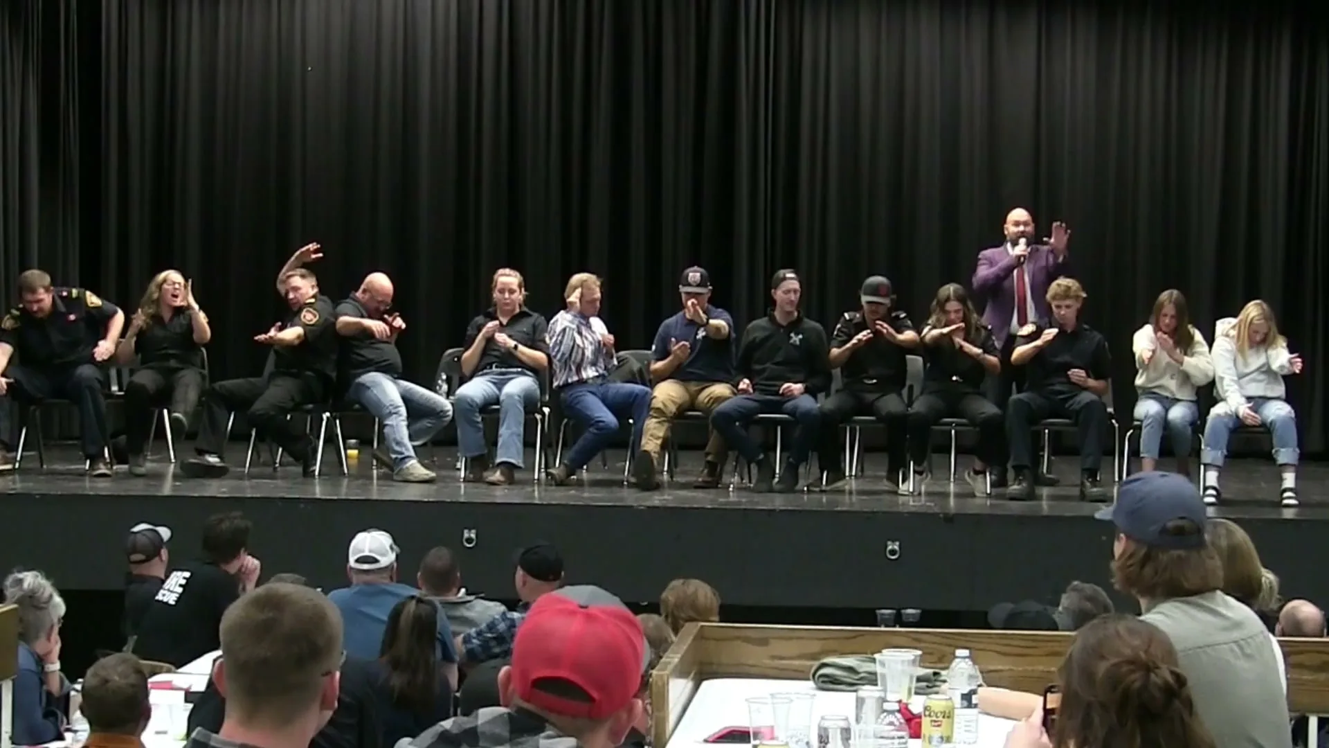 Jesse Lewis performing live comedy hypnosis with conference volunteers onstage
